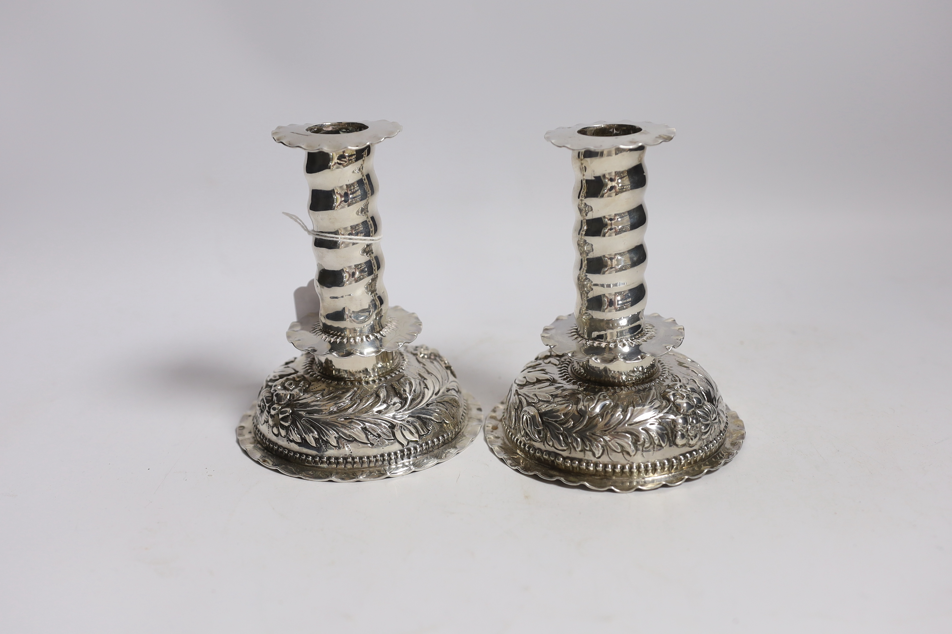 A matched pair of Carolean style silver dwarf candlesticks, London, 1880 & 1885, makers mark on one for George Fox, silver disc to base marked for Charles Stuart Harris, height 12.3cm, weighted.